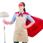 Image of woman in cape holding a mop