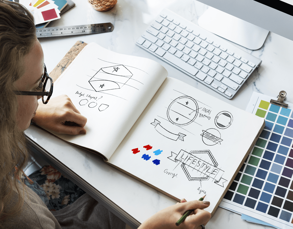 Girl Looking at drawings in notebook